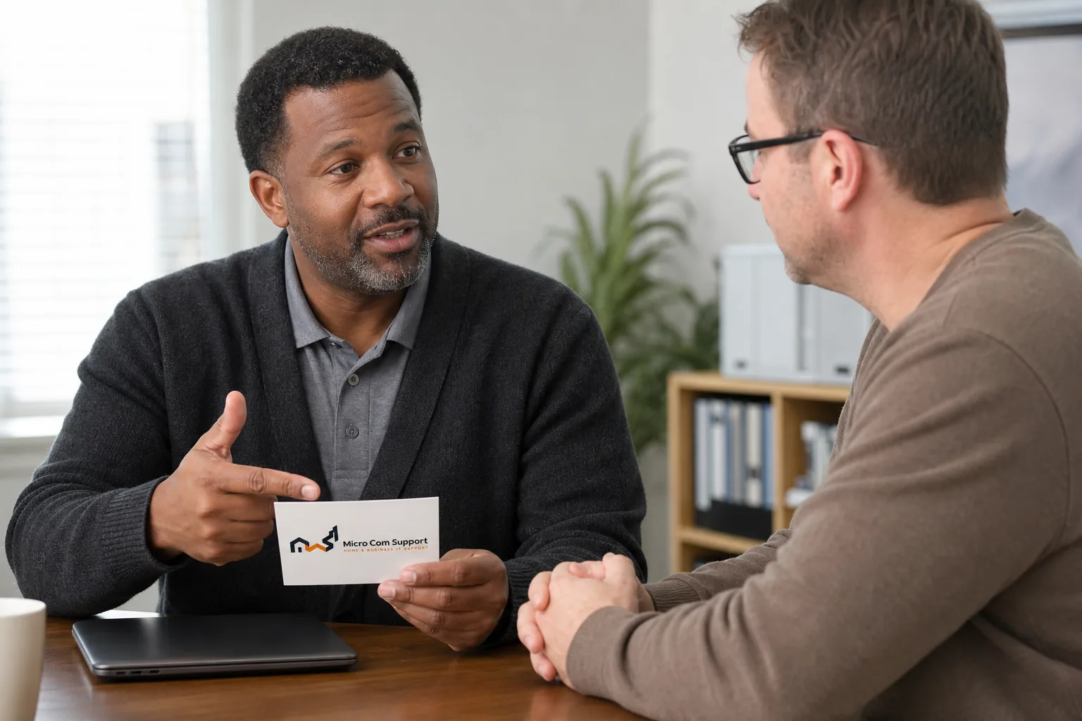 Security-focused technician explaining safe computer-support precautions to a customer